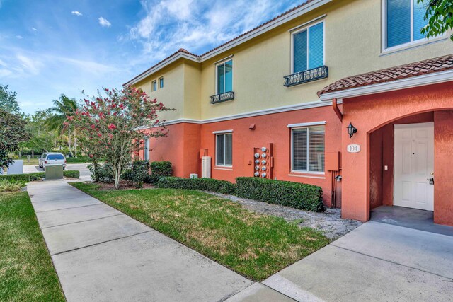 40 SE Sedona Cir Unit 104, Stuart, FL 34994 - view of home's exterior with stucco siding and a tile roof