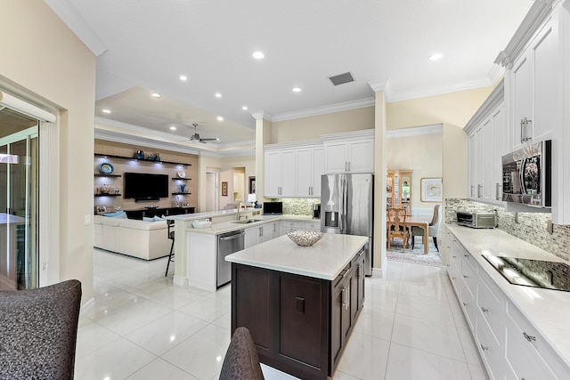 8271 Green Mountain Rd, Boynton Beach, FL 33473 - kitchen with appliances with stainless steel finishes, ornamental molding, decorative backsplash, open floor plan, and light countertops