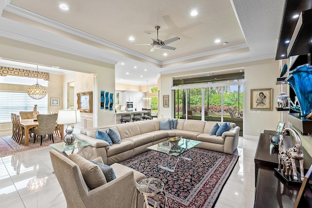 8271 Green Mountain Rd, Boynton Beach, FL 33473 - living room with ceiling fan, crown molding, a chandelier, a tray ceiling, and a textured ceiling