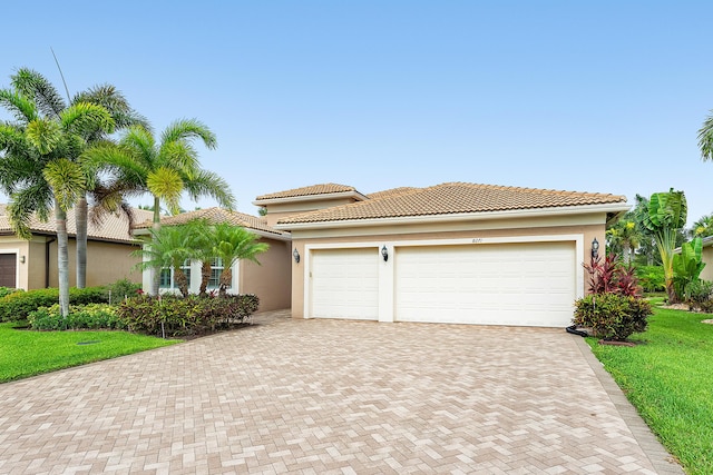 8271 Green Mountain Rd, Boynton Beach, FL 33473 - view of front of property featuring decorative driveway, stucco siding, an attached garage, and a front yard
