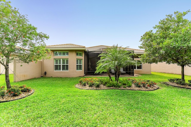 8271 Green Mountain Rd, Boynton Beach, FL 33473 - back of house featuring a tile roof, stucco siding, and a lawn