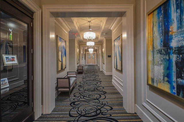 8271 Green Mountain Rd, Boynton Beach, FL 33473 - hallway featuring a chandelier, dark colored carpet, and ornamental molding