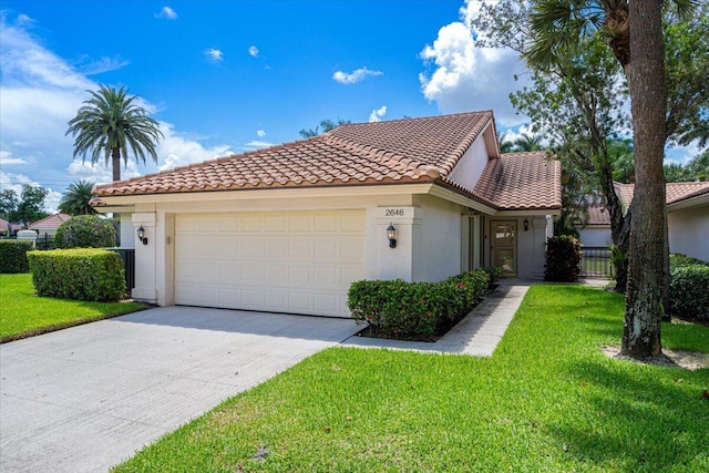 2646 Mohawk Cir, West Palm Beach, FL 33409 - mediterranean / spanish-style house featuring a garage, stucco siding, a tile roof, and a front yard