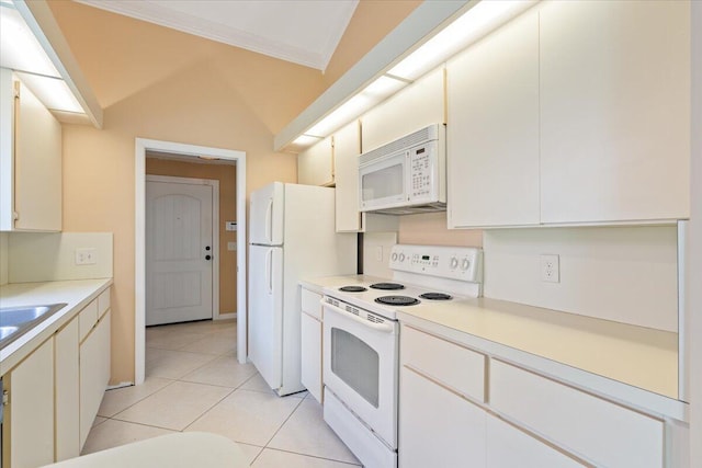 2646 Mohawk Cir, West Palm Beach, FL 33409 - kitchen with white appliances, light tile patterned flooring, light countertops, ornamental molding, and lofted ceiling