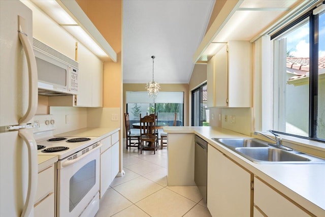 2646 Mohawk Cir, West Palm Beach, FL 33409 - kitchen featuring white appliances, a chandelier, light countertops, light tile patterned flooring, and decorative light fixtures