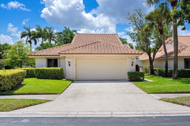 2646 Mohawk Cir, West Palm Beach, FL 33409 - mediterranean / spanish home with a tiled roof, stucco siding, a front lawn, an attached garage, and concrete driveway