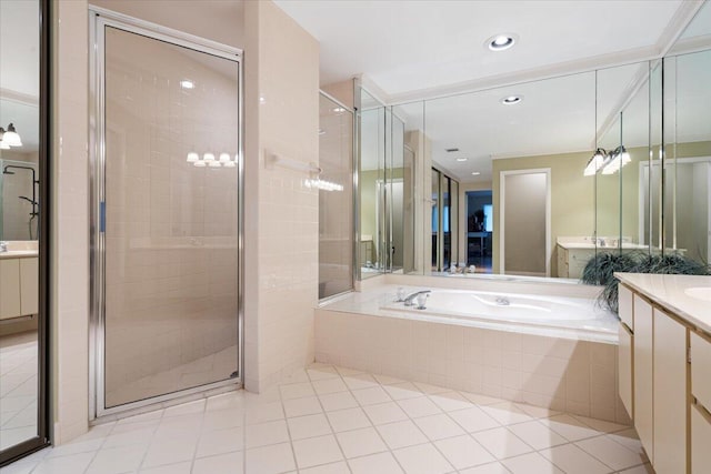 2646 Mohawk Cir, West Palm Beach, FL 33409 - full bath featuring vanity, a garden tub, a shower stall, tile patterned flooring, and recessed lighting