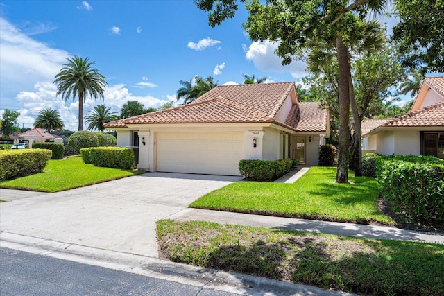 2646 Mohawk Cir, West Palm Beach, FL 33409 - mediterranean / spanish-style home featuring an attached garage, a tiled roof, and stucco siding