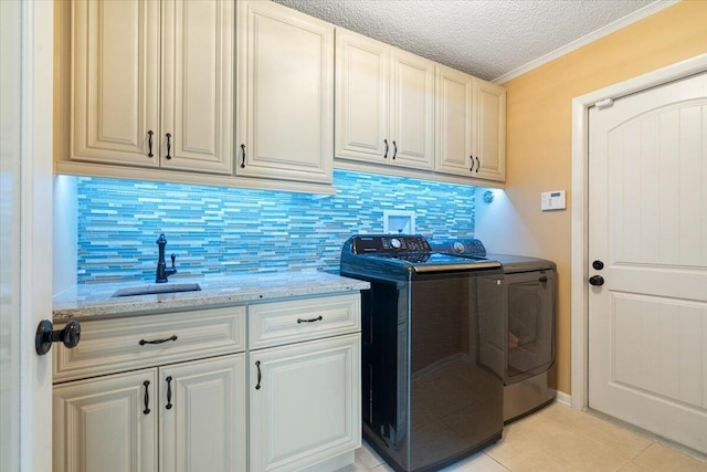 2646 Mohawk Cir, West Palm Beach, FL 33409 - laundry area with cabinet space, separate washer and dryer, light tile patterned floors, a textured ceiling, and ornamental molding