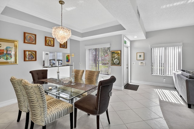 7824 Lexington Club Blvd Unit A, Delray Beach, FL 33446 - dining room featuring a chandelier, ornamental molding, light tile patterned flooring, a textured ceiling, and a tray ceiling