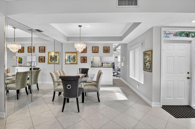 7824 Lexington Club Blvd Unit A, Delray Beach, FL 33446 - dining space featuring a raised ceiling, a chandelier, light tile patterned flooring, and crown molding
