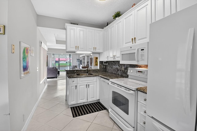 7824 Lexington Club Blvd Unit A, Delray Beach, FL 33446 - kitchen featuring white appliances, white cabinetry, a peninsula, light tile patterned floors, and a textured ceiling