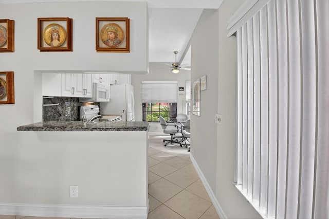 7824 Lexington Club Blvd Unit A, Delray Beach, FL 33446 - kitchen featuring white appliances, light tile patterned floors, white cabinets, ceiling fan, and a peninsula