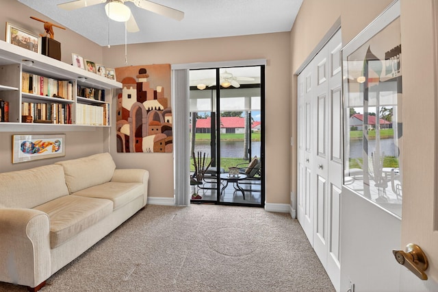 7824 Lexington Club Blvd Unit A, Delray Beach, FL 33446 - sitting room with a ceiling fan, carpet flooring, and a water view