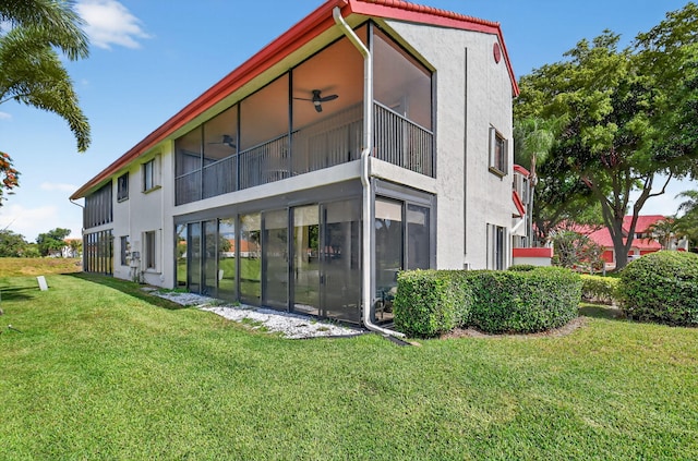7824 Lexington Club Blvd Unit A, Delray Beach, FL 33446 - rear view of house featuring stucco siding, a lawn, and a sunroom