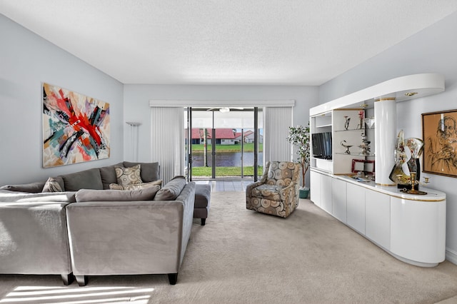 7824 Lexington Club Blvd Unit A, Delray Beach, FL 33446 - living room featuring light carpet and a textured ceiling
