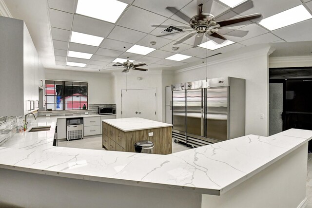 7824 Lexington Club Blvd Unit A, Delray Beach, FL 33446 - kitchen with a ceiling fan, stainless steel built in refrigerator, light stone countertops, backsplash, and ornamental molding