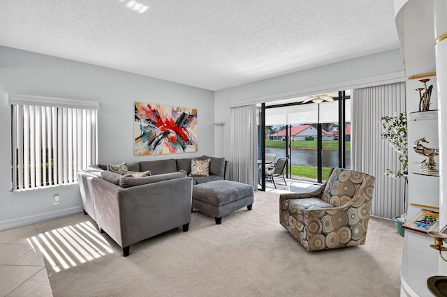 7824 Lexington Club Blvd Unit A, Delray Beach, FL 33446 - living area featuring a textured ceiling, a water view, and carpet flooring