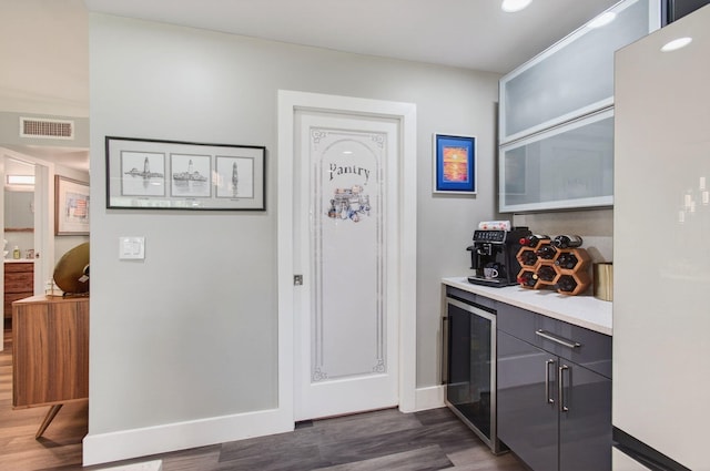1170 S Drive Cir Unit B, Delray Beach, FL 33445 - indoor dry bar featuring wine cooler, freestanding refrigerator, dark wood-style floors, and recessed lighting