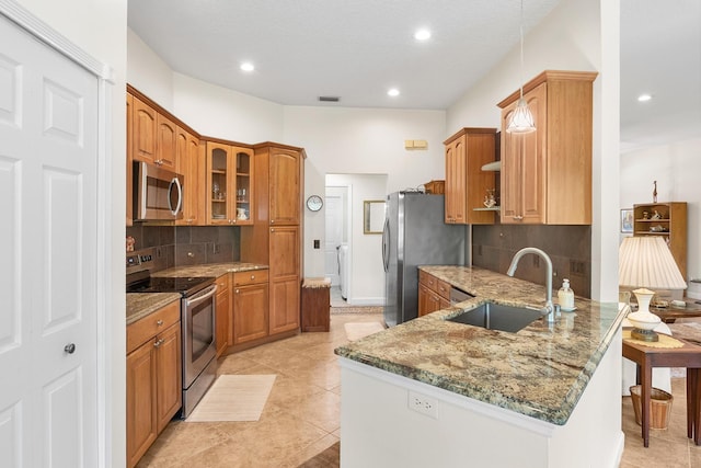 1200 SW Arrowhead Ct, Palm City, FL 34990 - kitchen featuring appliances with stainless steel finishes, a peninsula, stone countertops, decorative backsplash, and recessed lighting