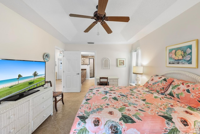 1200 SW Arrowhead Ct, Palm City, FL 34990 - bedroom with a tray ceiling, tile patterned flooring, and a ceiling fan