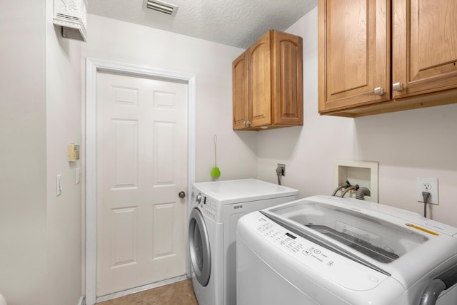 1200 SW Arrowhead Ct, Palm City, FL 34990 - laundry room with cabinet space, washer and dryer, and a textured ceiling