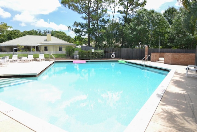 1200 SW Arrowhead Ct, Palm City, FL 34990 - community pool with a patio and view of wooded area