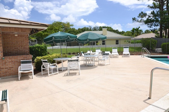 1200 SW Arrowhead Ct, Palm City, FL 34990 - view of patio / terrace with a community pool and outdoor dining area