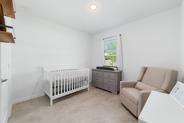 1312 SW Calmar Ave Unit 164, Port Saint Lucie, FL 34953 - bedroom with a nursery area and light tile patterned floors