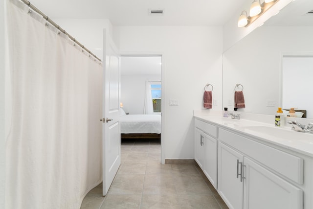 1312 SW Calmar Ave Unit 164, Port Saint Lucie, FL 34953 - bathroom featuring double vanity, ensuite bathroom, and tile patterned flooring