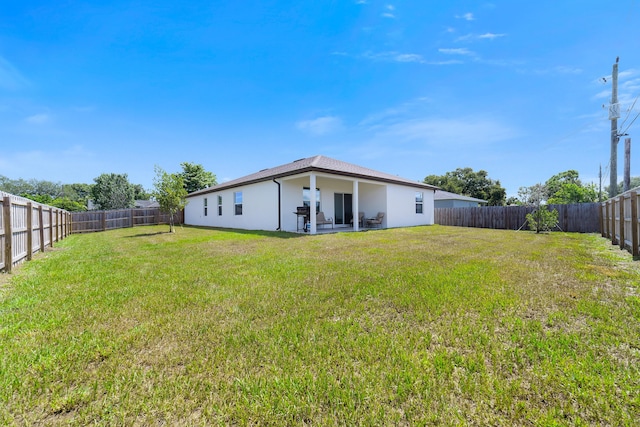 1312 SW Calmar Ave Unit 164, Port Saint Lucie, FL 34953 - back of property featuring a fenced backyard, stucco siding, and a patio