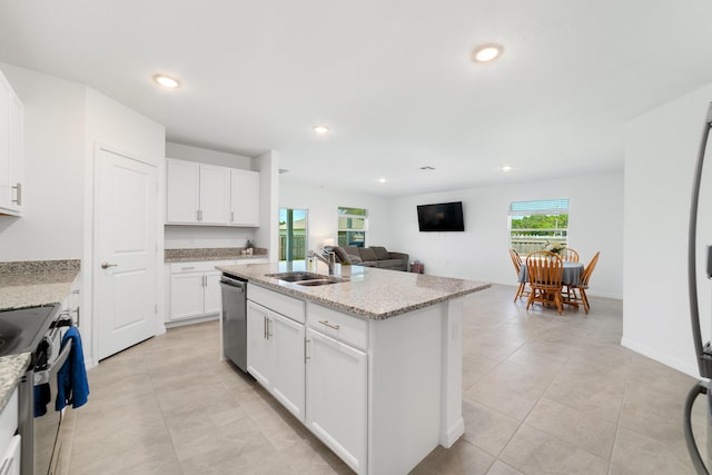 1312 SW Calmar Ave Unit 164, Port Saint Lucie, FL 34953 - kitchen with stainless steel dishwasher, electric stove, light tile patterned floors, a center island with sink, and recessed lighting