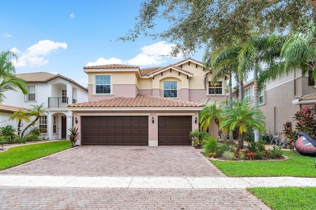 8183 Emerald Winds Cir, Boynton Beach, FL 33473 - mediterranean / spanish-style home featuring stucco siding, decorative driveway, a tiled roof, and an attached garage