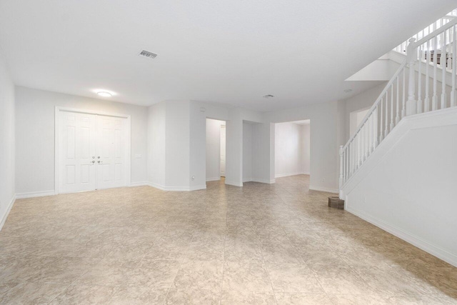 8183 Emerald Winds Cir, Boynton Beach, FL 33473 - unfurnished living room featuring stairway and light floors