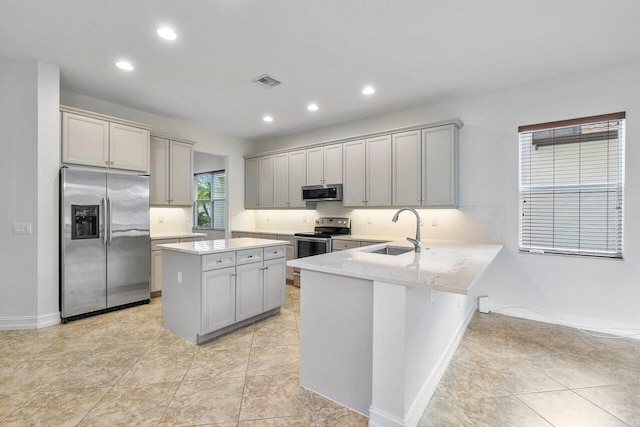 8183 Emerald Winds Cir, Boynton Beach, FL 33473 - kitchen with stainless steel appliances, gray cabinetry, tasteful backsplash, recessed lighting, and a center island