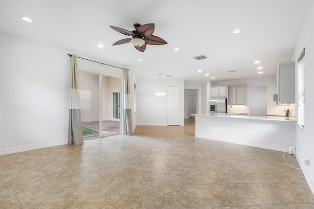 8183 Emerald Winds Cir, Boynton Beach, FL 33473 - unfurnished living room featuring a ceiling fan, recessed lighting, healthy amount of natural light, and light tile patterned floors