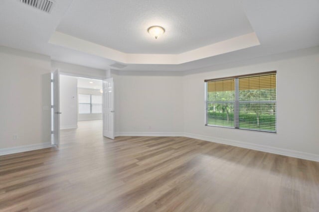 8183 Emerald Winds Cir, Boynton Beach, FL 33473 - spare room with a tray ceiling and light wood finished floors
