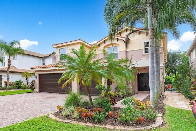 8183 Emerald Winds Cir, Boynton Beach, FL 33473 - mediterranean / spanish-style home with stucco siding, driveway, an attached garage, and a tile roof