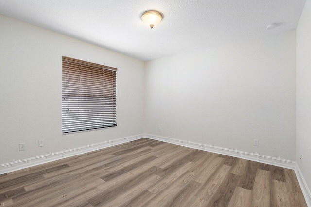 8183 Emerald Winds Cir, Boynton Beach, FL 33473 - empty room featuring wood finished floors and baseboards