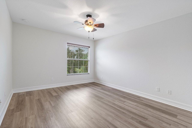 8183 Emerald Winds Cir, Boynton Beach, FL 33473 - empty room with wood finished floors and a ceiling fan