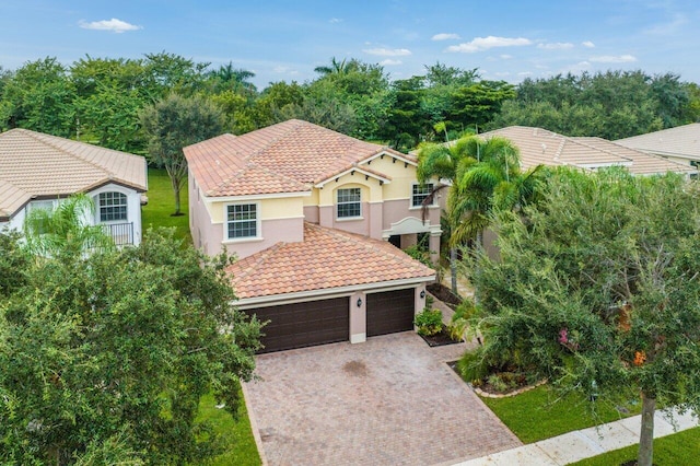 8183 Emerald Winds Cir, Boynton Beach, FL 33473 - view of front facade with a tiled roof, decorative driveway, stucco siding, a garage, and a front yard