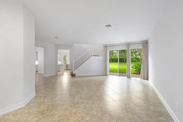 8183 Emerald Winds Cir, Boynton Beach, FL 33473 - unfurnished living room with stairway and light tile patterned floors
