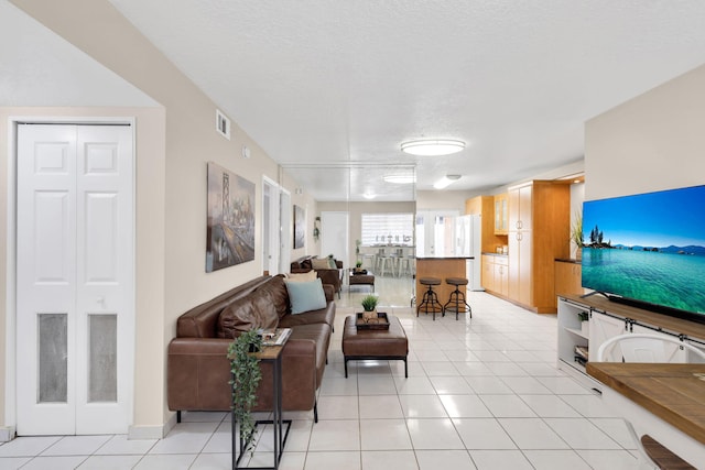 7853 W 36th Ave Unit 104, Hialeah, FL 33018 - living room featuring light tile patterned flooring and a textured ceiling