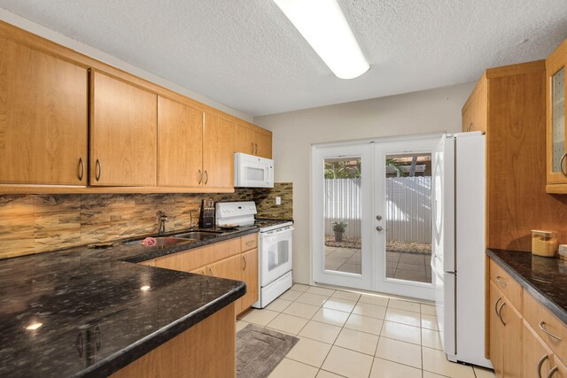 7853 W 36th Ave Unit 104, Hialeah, FL 33018 - kitchen with white appliances, french doors, tasteful backsplash, a textured ceiling, and dark stone countertops