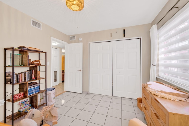 7853 W 36th Ave Unit 104, Hialeah, FL 33018 - bedroom featuring light tile patterned flooring, multiple windows, and a closet