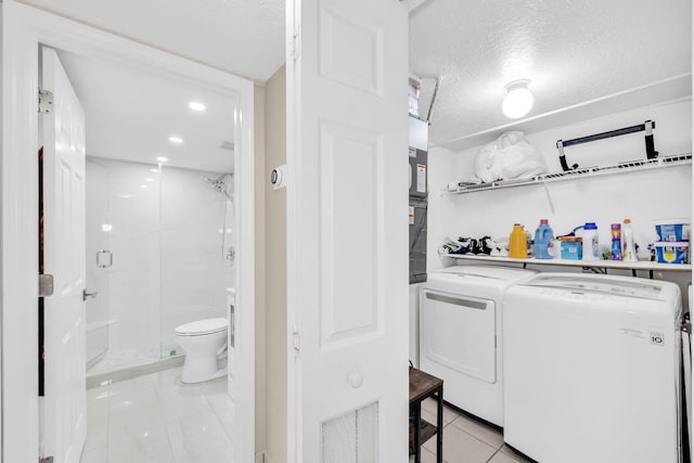7853 W 36th Ave Unit 104, Hialeah, FL 33018 - washroom with washer and clothes dryer, light tile patterned floors, a textured ceiling, and recessed lighting