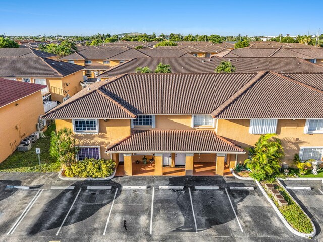 7853 W 36th Ave Unit 104, Hialeah, FL 33018 - view of building exterior with uncovered parking and a residential view