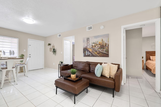 7853 W 36th Ave Unit 104, Hialeah, FL 33018 - living area featuring light tile patterned floors and a textured ceiling