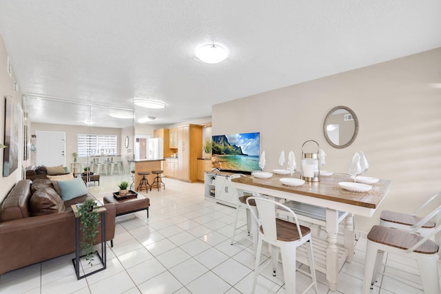 7853 W 36th Ave Unit 104, Hialeah, FL 33018 - dining area with a textured ceiling and light tile patterned floors