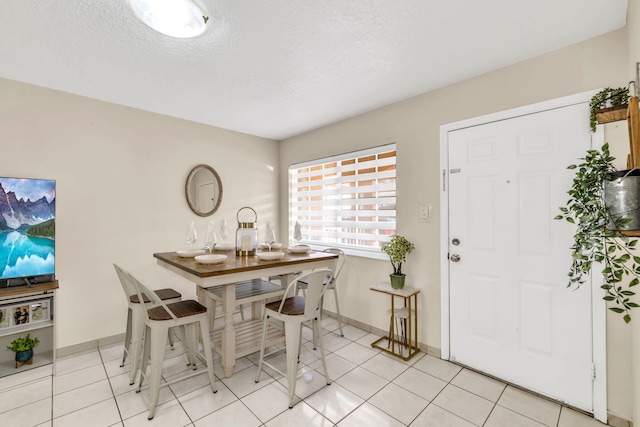 7853 W 36th Ave Unit 104, Hialeah, FL 33018 - dining space featuring light tile patterned floors and a textured ceiling